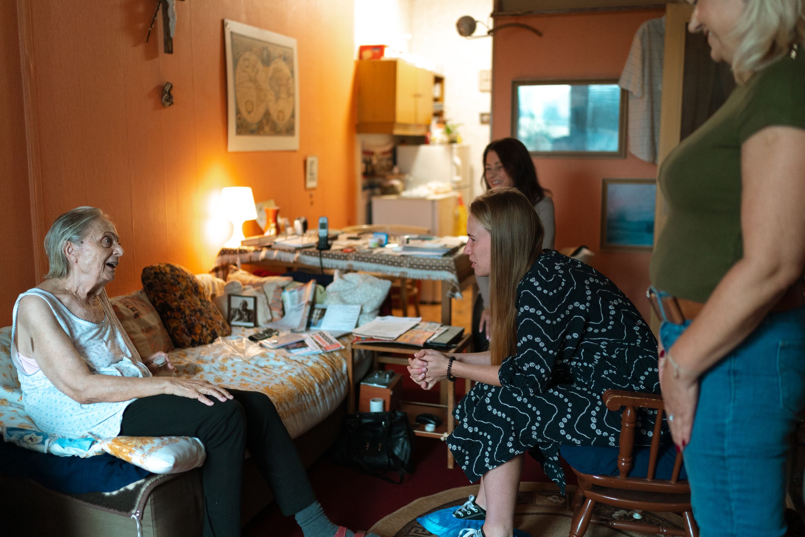 A heartwarming moment between family members in a cozy living room setting, showcasing intergenerational bonding.